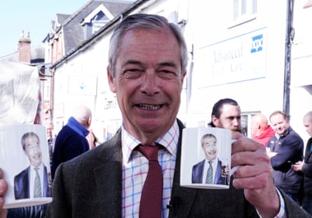 Nigel Farage holding a mug with his own image on