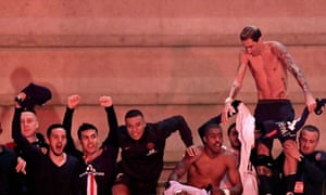 Paris Saint-Germain players including Kylian Mbappé (centre) celebrate with fans outside the Parc des Princes after defeating Borussia Dortmund behind closed doors.