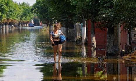 A woman walks along a street after floodwaters receded following the collapse of the Nova Kakhovka dam in the course of Russia-Ukraine conflict, in the town of Hola Prystan in the Kherson region, Russian-controlled Ukraine, June 16, 2023. REUTERS/Alexander Ermochenko