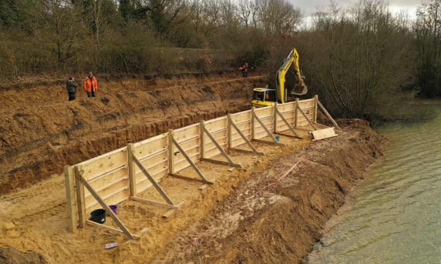 Build it and they will come: a digger moves sand into the wooden mould.