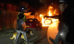 A police car burns as officers are deployed on the streets of Hartlepool after a violent disorder. 