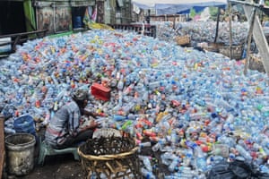 Banda Aceh, Indonesia A worker collects plastic bottles to sell at a dump site