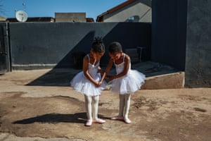 Two young ballet dancers curtsy