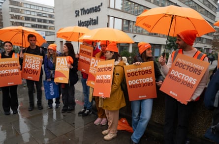 Resident doctors hold placards on a picket line