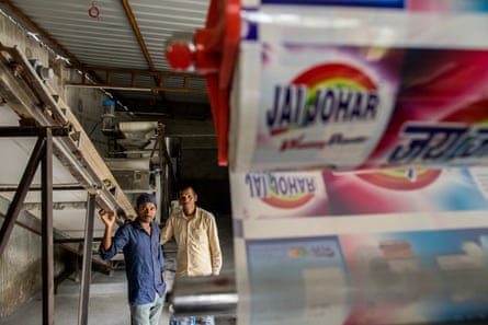 Bhole Nath Singh (in blue) and his cousin Patar Sai Armo at their detergent factory in Chhattisgarh.