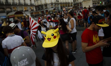 Spanish fans play the highly addictive Pokemon Go game during a gathering in central Madrid, Spain to play the computer game. 