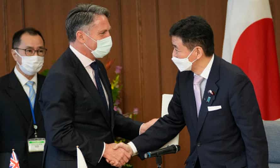 Richard Marles shakes hands with Japanese defence minister Nobuo Kishi