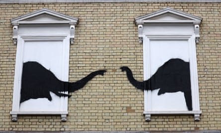 Two elephants painted on to the side of house.