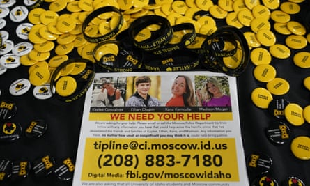 A flyer seeking information about the murders of four University of Idaho students is displayed on a table along with buttons and bracelets during a vigil last month.