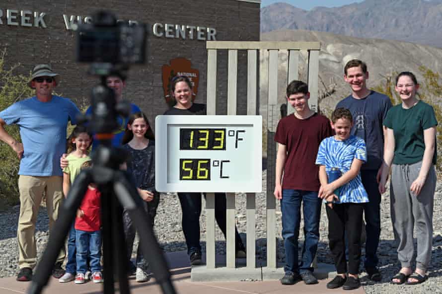 People visit the unofficial thermometer reading 56C (133F) at Furnace Creek Visitor Center on 11 July.