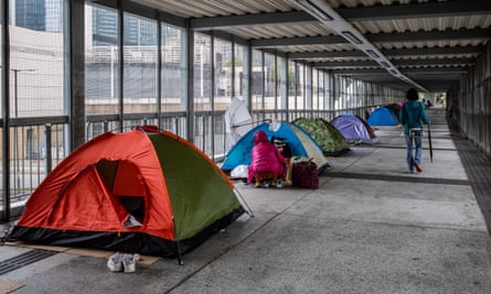 Foreign Domestic Workers gather together in Admiralty on their one day off a week. Due to social distancing regulations, many foreign workers were careful to limit their groups to two as they sheltered from the cold and rain.