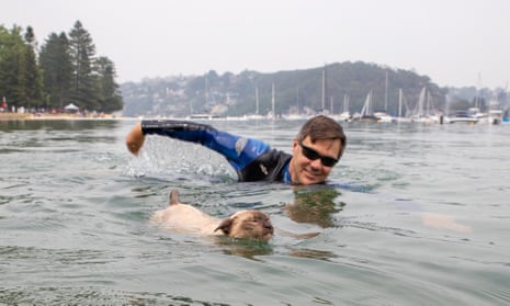 Preference whisperer Glenn Druery with his pet Tonkinese cat Gus, who he is entering in this year’s Scotland Island dog swimming race. Gus apparently also enjoys standup paddle-boarding, cycling and hiking.