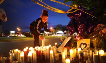 Mourners light candles at a makeshift memorial outside of Tops market after the shooting.