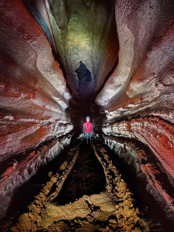 view of a cave's interior with a person in the middle