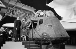 The Queen looks inside the Apollo 14 command module, a spaceship that visited the moon in February 1971, during a tour in Downey, California, on 28 February 1983