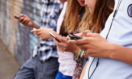 Teenagers using mobile phones