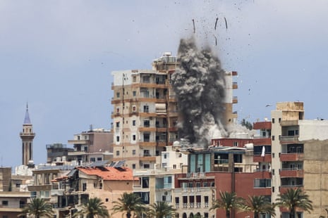 Smoke and debris rise from a building following an airstrike.