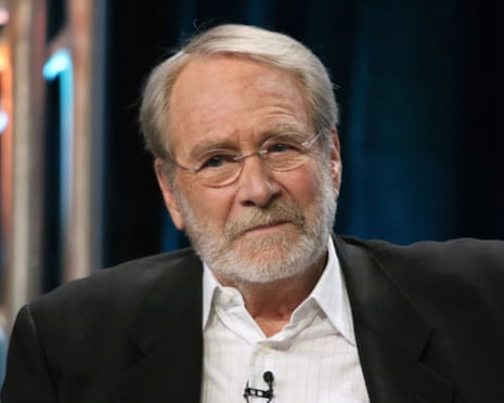 white man wearing glasses and black suit