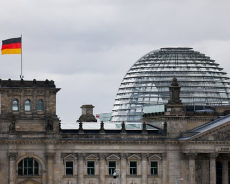 The German flag flutters outside the Reichstag building, the seat of the German parliament, the Bundestag, in Berlin, Germany.