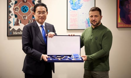 Fumio Kishida meets Volodymyr Zelenskyy and hold a tray of medals