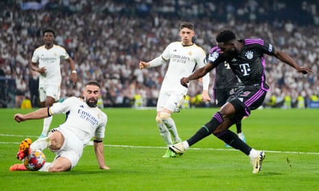Real Madrid’s Dani Carvajal (left) gets an important touch to a shot by Bayern’s Alphonso Davies.