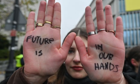 A student protester holds up her hands, which carry the message: 'Future is in our hands', during a climate demonstration in Warsaw, Poland, in November.