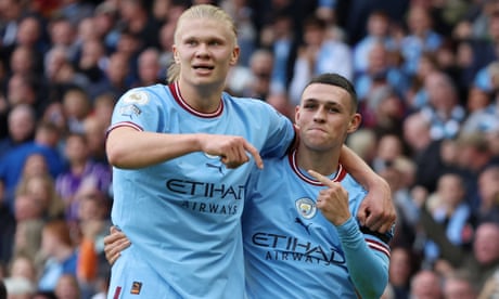 Phil Foden celebrates scoring Manchester City's sixth goal with Erling Haaland, completing his hat-trick, against Manchester United in the Premier League match at the Etihad Stadium