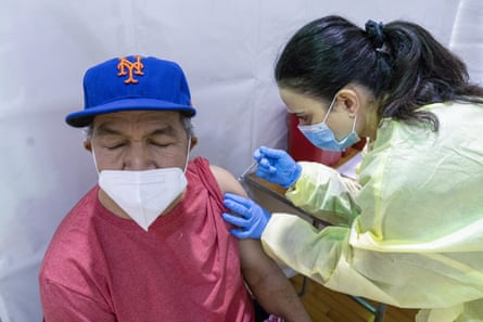 Registered nurse gives Gustavo Hernandez the first dose of coronavirus vaccine at a pop-up vaccination site in the Bronx borough of New York on 31 January.