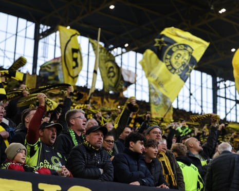 Borussia Dortmund fans watch a game in the team's supporters' section.