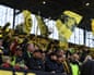 Borussia Dortmund fans watch a game in the team's supporters' section.