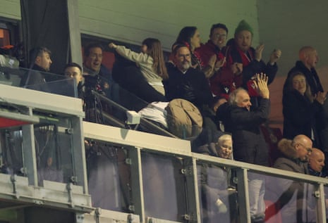 Actor, entrepreneur and Wrexham co-owner Ryan Reynolds (right of the column) celebrates after Liberato Cacace of Wrexham (not pictured) opens the scoring.