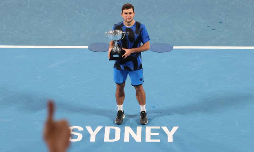 Celebrate with a trophy after Russia's Aslan Karatsev defeats Andy Murray