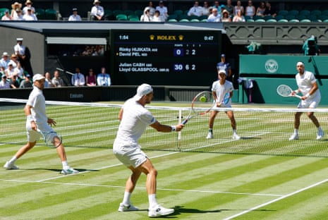 Lloyd Glasspool (left) looks on as Julian Cash flings a forehand to Rinky Hijikata (second right) and David Pel.