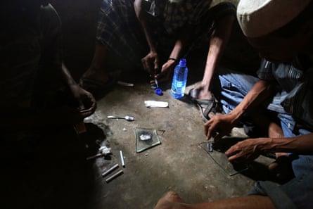 Heroin users prepare their fix  in Lamu, Kenya