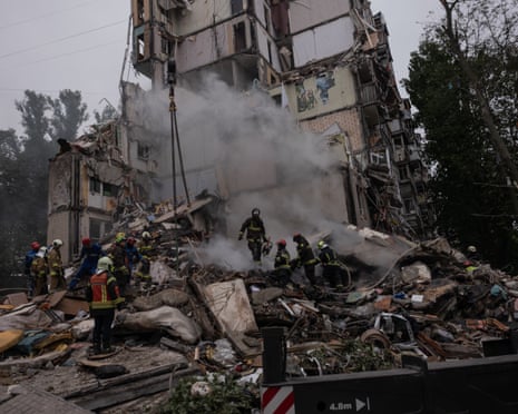 Rescue workers search for family in the destruction of residential buildings after a massive missile attack that struck Kyiv.