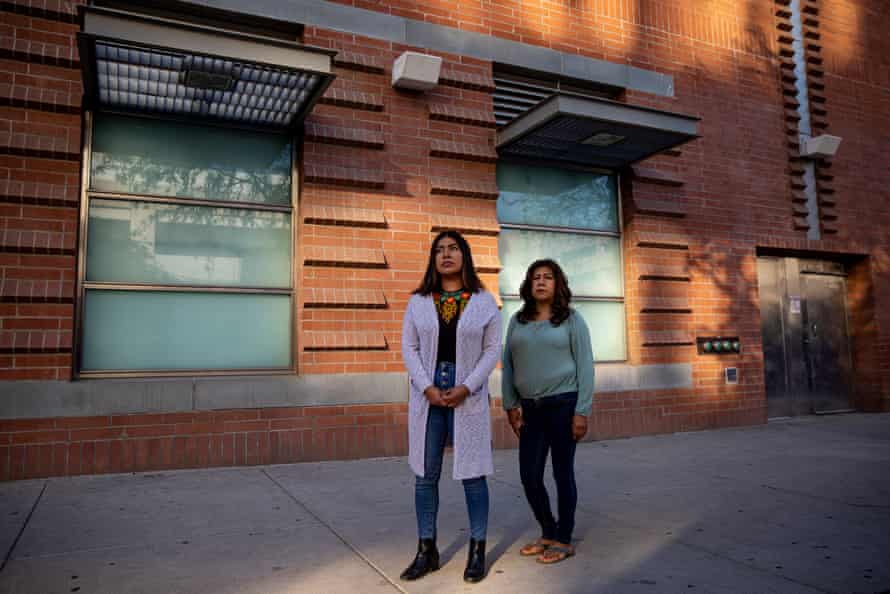 Two women standing outside of a building