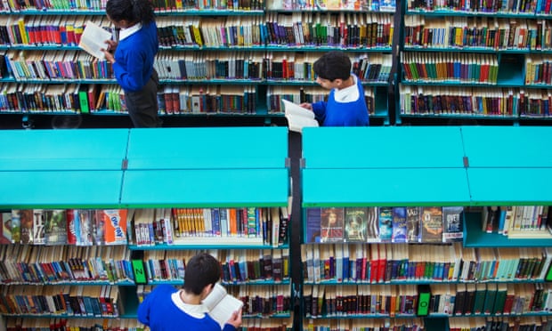 teenager readers browsing in a school library.