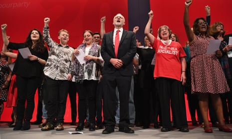 Jeremy Corbyn sings The Red Flag on stage with party members at the party conference.