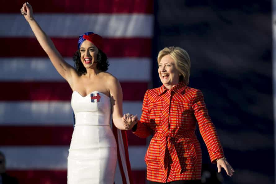 Democratic presidential candidate Hillary Clinton arrives with singer Katy Perry during a campaign rally.