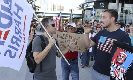 A supporter of President Joe Biden, left, argues with supporters of former president Donald Trump outside the Amway Center in Orlando, Florida this month.