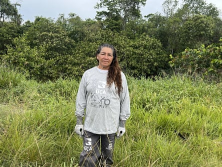 Eugênia Maria Santos standing in long grass.