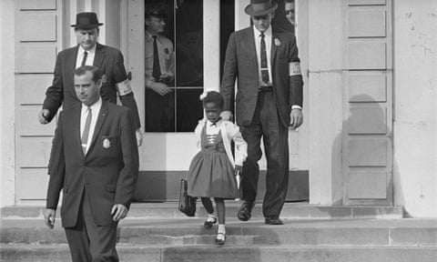 Ruby Bridges with an escort of US deputy marshals leaves school in November 1960.