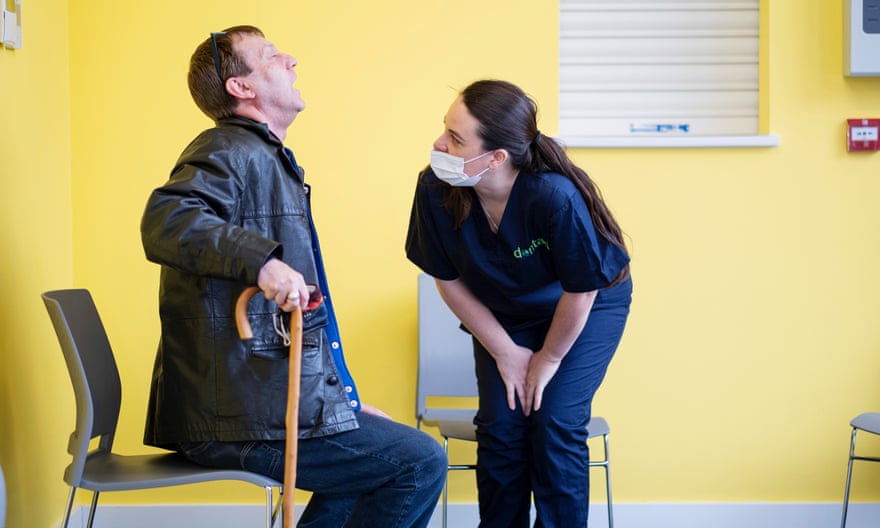 Natalie Bradley, Dentaid’s clinical director and an NHS dentist, assesses a patient in the Bury St Edmunds community centre.