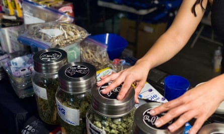 Bags of psilocybin mushrooms, left, are seen displayed at a pop-up cannabis market in Los Angeles on 6 May 2019.
