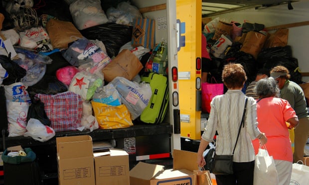 Women donate clothing that is piled into trucks at a relief drive for the victims of Hurricane Katrina