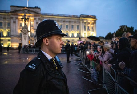 A police officer is one of hundreds deployed at Buckingham Palace for the arrival of the Queen’s coffin