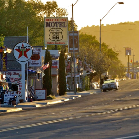 Roadside motel and gas station signs along the road
