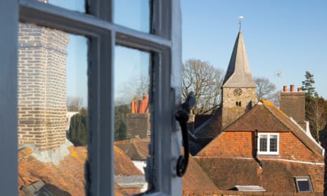 View through open window over cottage roof tops