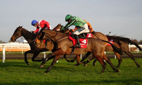 Hewick (green) ridden by Gavin Sheehan goes on to wins the Ladbrokes King George VI Chase.