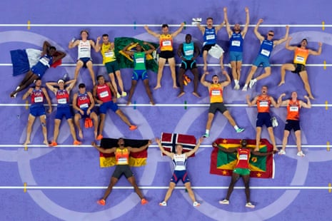 Men’s decathlon competitors including medalists Leo Neugebauer, Markus Rooth and Lindon Victor (bottom row) lay on the track with fellow competitors after completing the last event.
